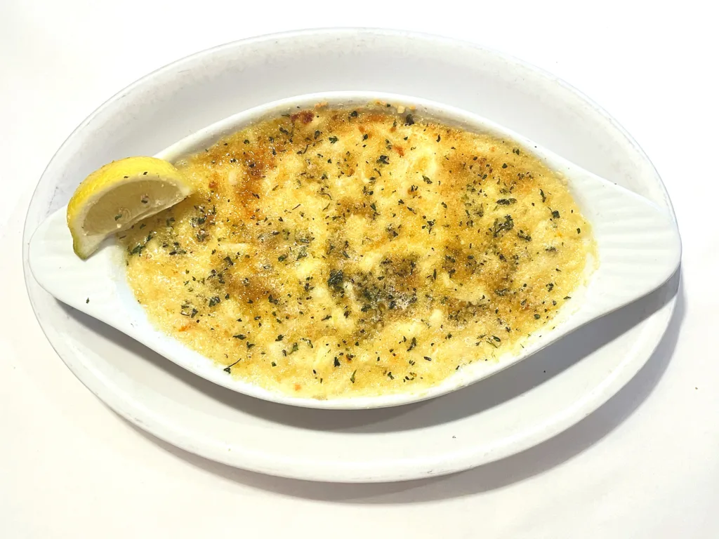 Fury's Restaurant crabmeat au gratin on a plate with lemon